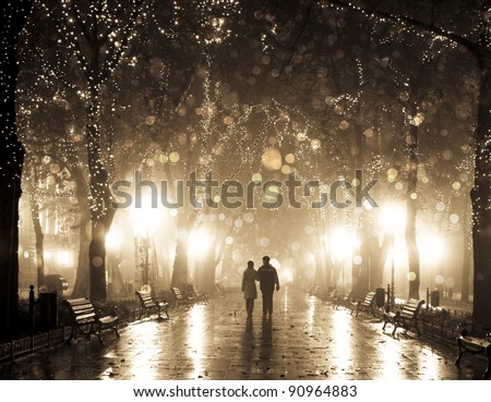 Couple walking at alley in night lights. Photo in vintage multicolor style. Royalty-Free Stock Photo #90964883