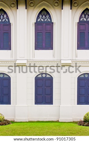 White wall with  Gothic  blue wood windows