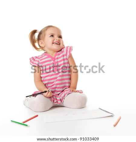 Portrait of lovely girl holding a pencil. drawing in copybook and looking at copyspace. shooting in the studio  on white background.