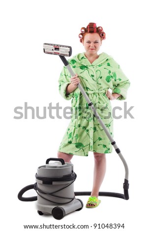 stereotypical houswife with hair rollers holding vacuum cleaner on white background