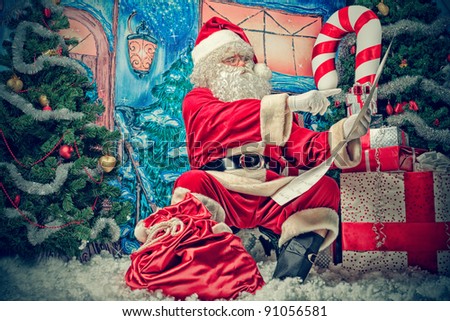 Santa Claus posing with a list of presents over Christmas background.