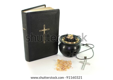 yellow incense with incense bowl and the Bible on white background
