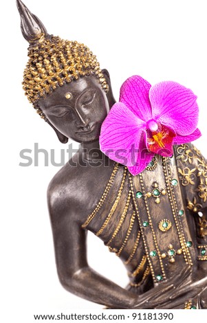 Buddha statue with orchid against white background