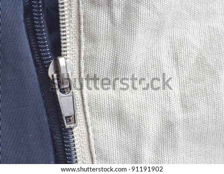 Opened zipper revealing a white background.