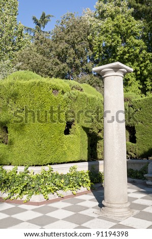 Column and garden. Picture taken in Cecilio Rodriguez Gardens, Retiro Park, Madrid, Spain