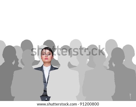 Leader concept. Portrait of young business woman standing with hands folded and grey people silhouettes are standing around her