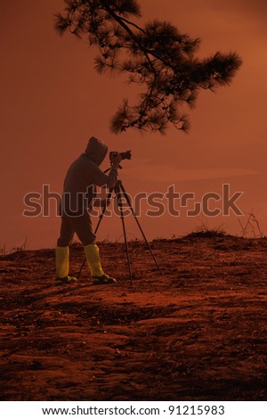 man with camera on sunset time