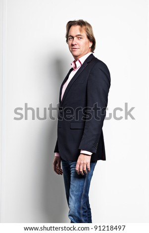 Portrait of smiling business man against white wall in office