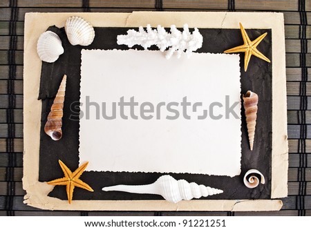 Marine theme frame of paper sheets and seashells on a wooden mat.