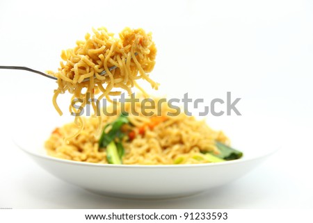 picture of fried noodles with vegetables on white background.