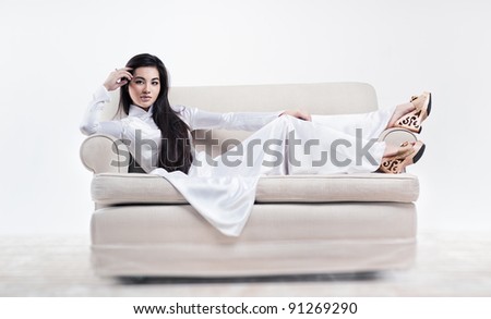 Young vietnamese woman resting on sofa.