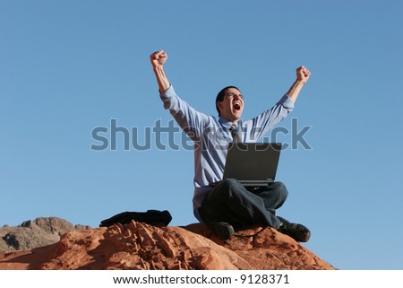 Ecstatic businessman with his laptop