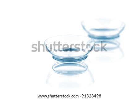 Two contact lenses with reflections, isolated on a white background Royalty-Free Stock Photo #91328498