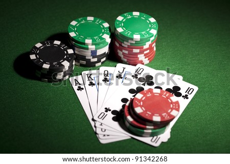 Poker cards and gambling chips on green background
