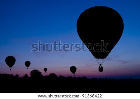 Silhouette of the hot air balloon on a sunset background.