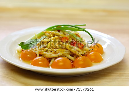 Dish of tiny silver fish with cherry tomatoes and green onion