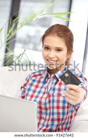 picture of happy woman with laptop computer and credit card