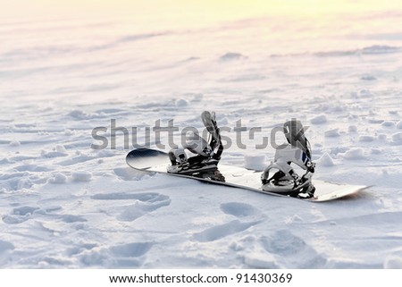 Snowboarding in the snow at sunset