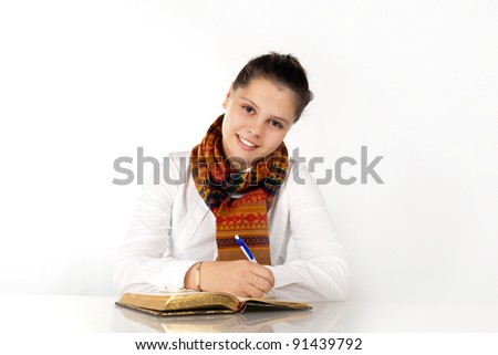 Young girl studying and looking at the camera