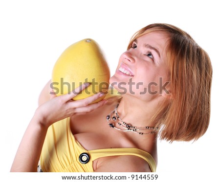 Girl holds in really big citrus fruit - pamelo