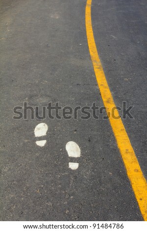 Walking Track With Yellow Footprints Painted On Road