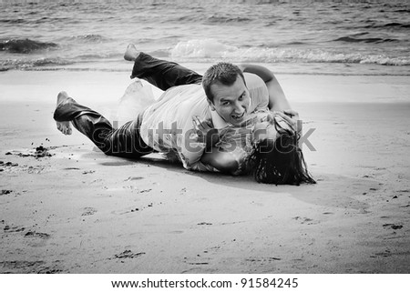 a happy married couple having fun on the beach
