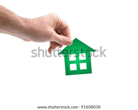 A conceptual house image held by a hand
