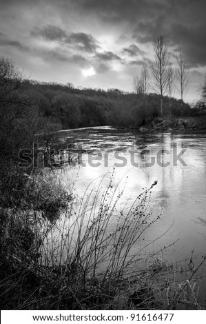 english river in flood in winter black and white
