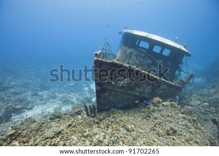 The wreck of the Mr. Bud, a former shrimping boat, scuttled off the island of Roatan, Honduras and now used as a scuba diving site. Royalty-Free Stock Photo #91702265