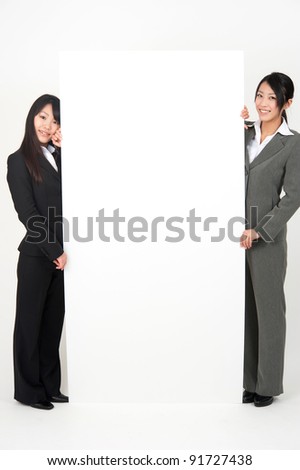 asian businesswomen holding a blank whiteboard isolated on white background