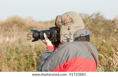 woman carrying out photography on a autumn day.