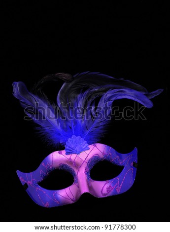 Fancy Purple and Blue Feathered Mask isolated on a black velvet background