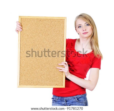 Pretty young blond woman holding a cork board isolated on white looking straight