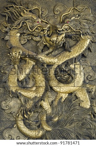 stucco golden dragon on the temple wall, Thailand