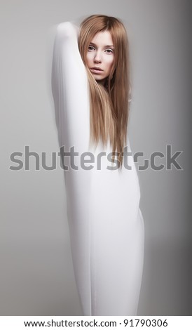 Graceful female silhouette in white clothes - studio shot