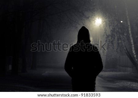 Stranger walking the streets on a cold foggy night Royalty-Free Stock Photo #91833593