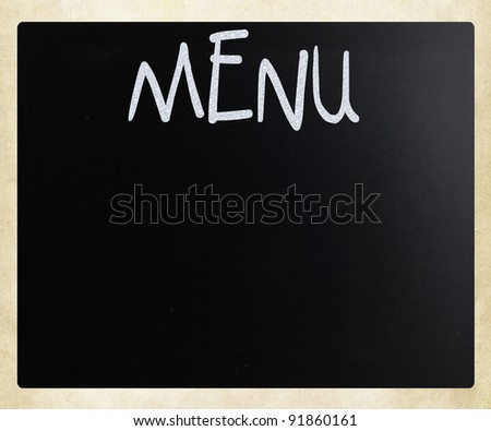 The word "Menu" handwritten with white chalk on a blackboard