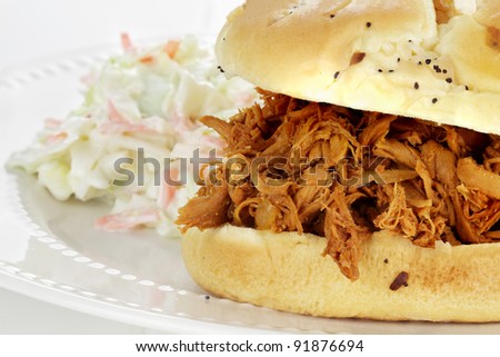 Close up of pulled chicken sandwich with coleslaw. Shallow depth of field.