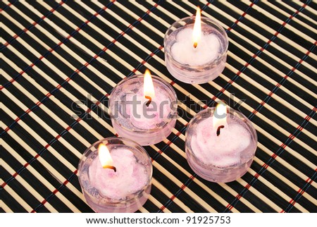  Pink candles on wooden math.
