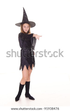 witch in black dress and hat standing