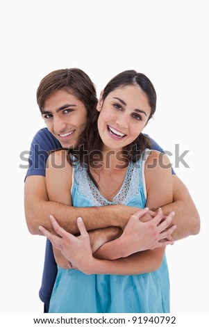Portrait of a charming couple embracing each other against a white background