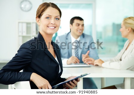 A beautiful businesswoman looking at camera in working environment