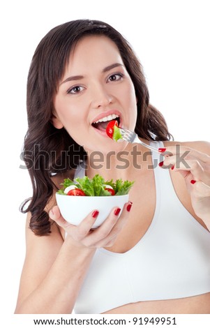 Young girl eating fresh salad