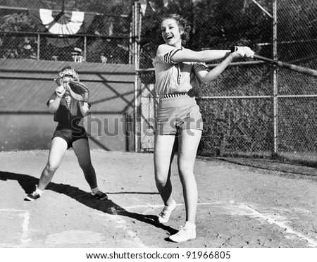 Two women playing baseball Royalty-Free Stock Photo #91966805
