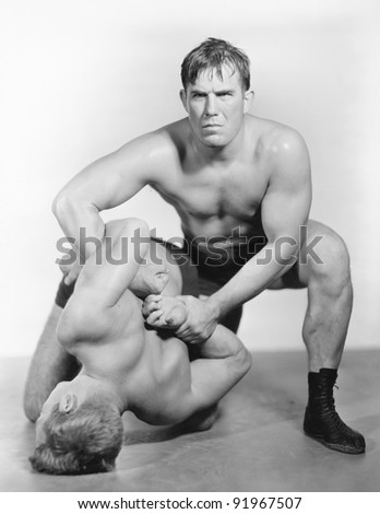 Two men wrestling with each other