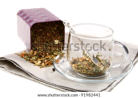 Set of dried herbs, fruits and spices in tea cup on a white background.