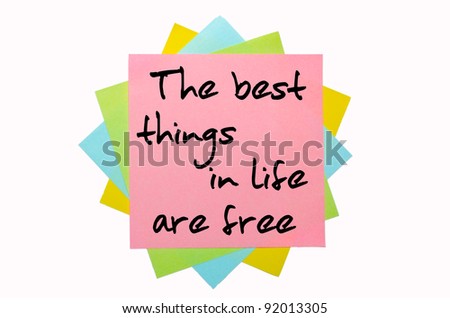 text " The best things in life are free " written by hand font on bunch of colored sticky notes
