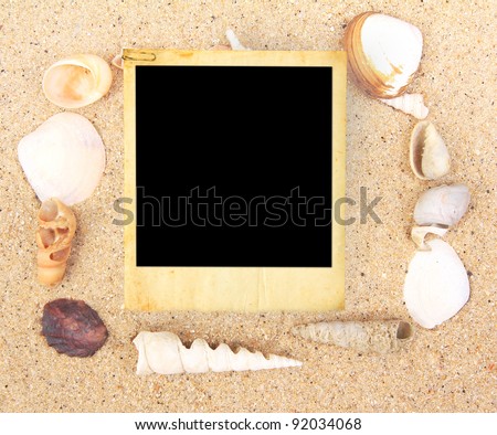 Vintage photo frame and Sea Shell on sand background