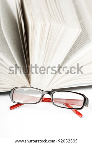 Study. Open Book with eyeglass on the white background
