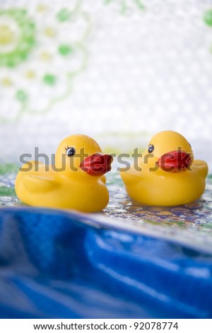 two little ducks toy floating on blue